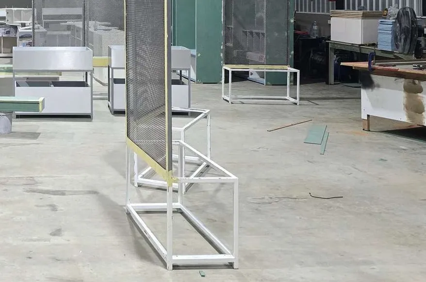 OUT factory floor with steel display frames and cabinets being pre-assembled